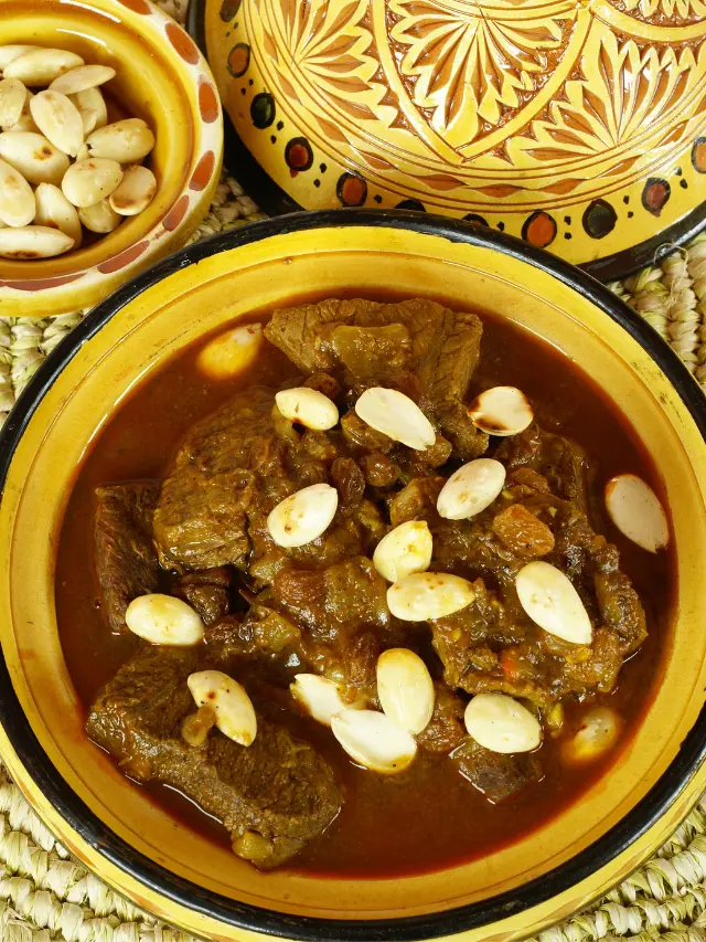 Looking for a gluten-free and dairy-free meal option? Then try a taste of Morocco to your table with this authentic mrouzia tagine recipe, a traditional Moroccan dish that's perfect for slow cooking lovers. Featuring succulent lamb, a bouquet of spices including cinnamon and turmeric, and a sweet twist with raisins and honey, it's a recipe that guarantees to impress. Perfect for a cozy night in or a special dinner! #MoroccanCuisine #LambStew #Spices #Saffron #TagineRecipes #TraditionalDishes