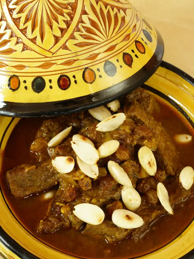 Looking for a gluten-free and dairy-free meal option? Then try a taste of Morocco to your table with this authentic mrouzia tagine recipe, a traditional Moroccan dish that's perfect for slow cooking lovers. Featuring succulent lamb, a bouquet of spices including cinnamon and turmeric, and a sweet twist with raisins and honey, it's a recipe that guarantees to impress. Perfect for a cozy night in or a special dinner! #MoroccanCuisine #LambStew #Spices #Saffron #TagineRecipes #TraditionalDishes