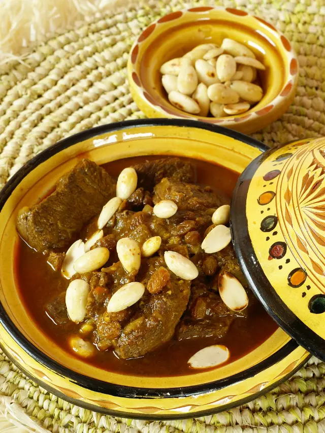 Looking for a gluten-free and dairy-free meal option? Then try a taste of Morocco to your table with this authentic mrouzia tagine recipe, a traditional Moroccan dish that's perfect for slow cooking lovers. Featuring succulent lamb, a bouquet of spices including cinnamon and turmeric, and a sweet twist with raisins and honey, it's a recipe that guarantees to impress. Perfect for a cozy night in or a special dinner! #MoroccanCuisine #LambStew #Spices #Saffron #TagineRecipes #TraditionalDishes
