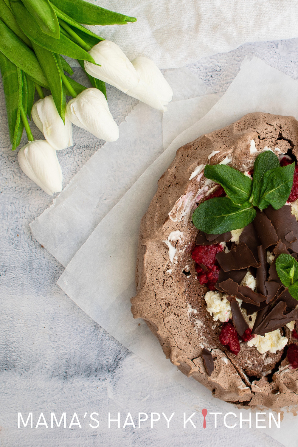 Pavlova is an Australian meringue desert. This one is a chocolate raspberry pavlova recipe that is topped with fresh cream and chocolate shavings. I'll admit that I am not the best meringue baker, but I took some liberties to make it easy peasy. I love the addition of the chocolate to the meringue. I am also in love with all berries. Raspberries are no exception! The secret to making this pavlova is to make sure it has no moisture while baking. That's why spring is the time to bake a pavlova.